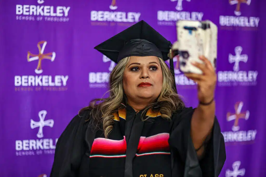 BST graduate taking a picture at the graduation ceremony.